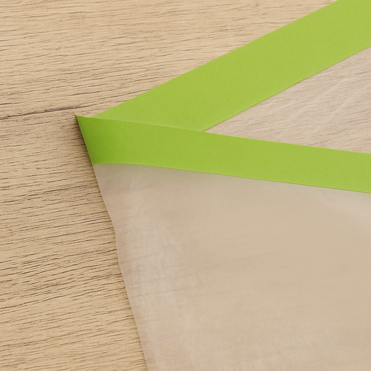 Pre-taped masking film unfolded to cover a wall for painting