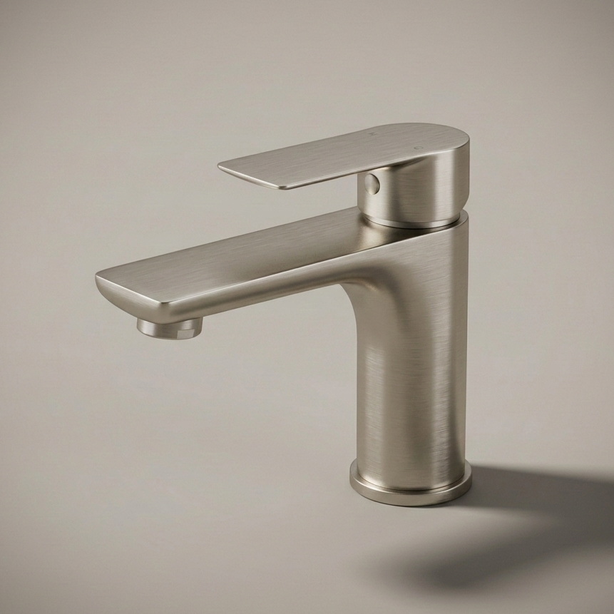 A modern, minimalist single-hole bathroom faucet made of stainless steel, installed on a white speckled quartz countertop against a white subway tile backsplash.