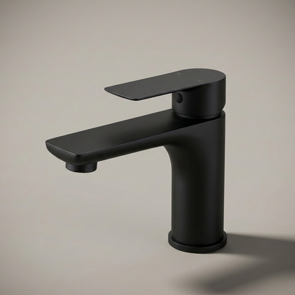 A modern, minimalist single-hole bathroom faucet made of stainless steel, installed on a white speckled quartz countertop against a white subway tile backsplash.
