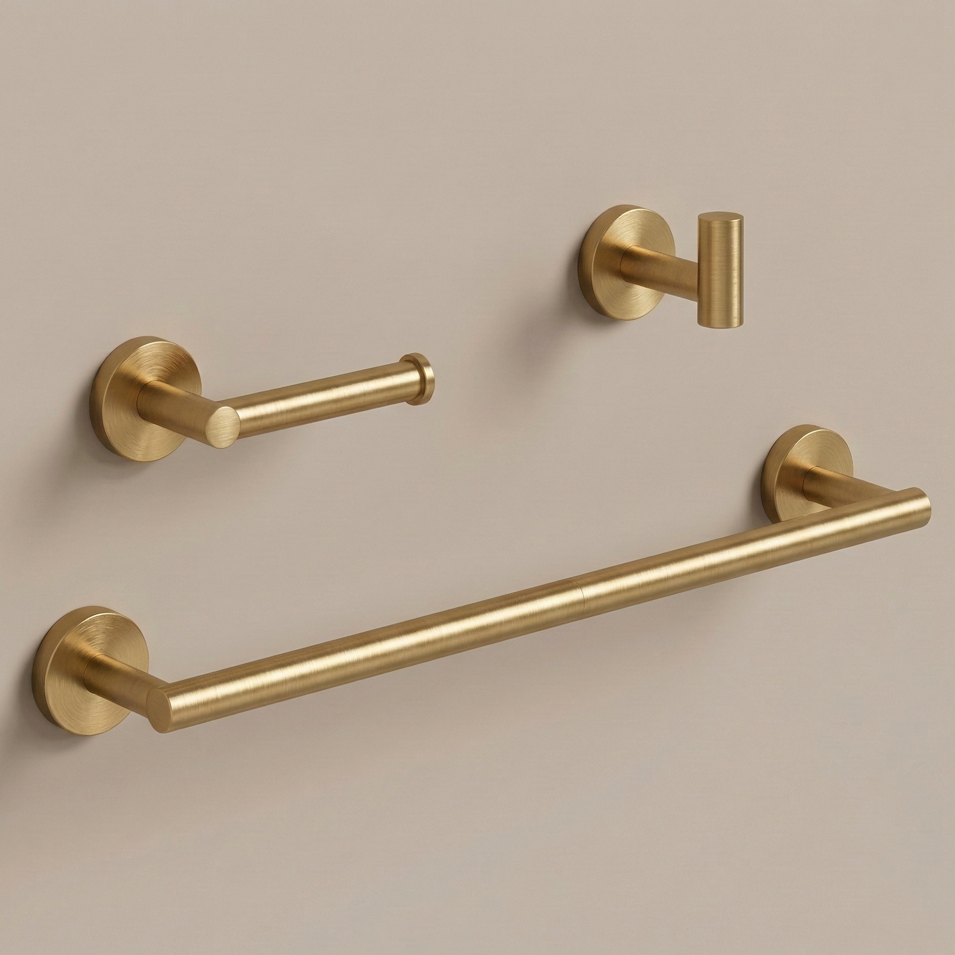 A luxurious, three-piece modern bathroom hardware set in a brushed gold finish, featuring a sleek 24-inch round towel bar, an anti-spin single-post toilet paper holder, and a minimalist cylindrical robe hook floating against a soft, neutral beige background.